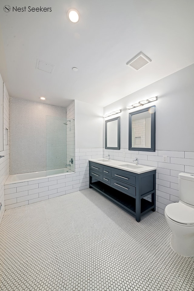 47-05 5th St Unit 203, New York City, NY 11101 - full bath with tile walls, double vanity, tile patterned floors, wainscoting, and tiled shower / bath combo