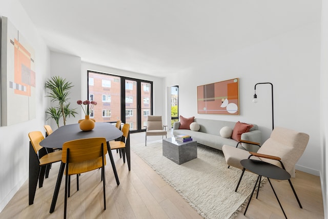 living area featuring light wood-type flooring and baseboards