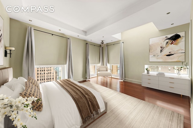 3 Hanover Sq Unit 22A, New York City, NY 10004 - bedroom with wood finished floors, recessed lighting, a raised ceiling, and baseboards