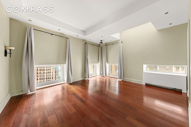 3 Hanover Sq Unit 22A, New York City, NY 10004 - unfurnished room with hardwood / wood-style floors, baseboards, a tray ceiling, and recessed lighting