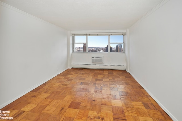 empty room with a baseboard heating unit, a wall unit AC, crown molding, and light parquet flooring