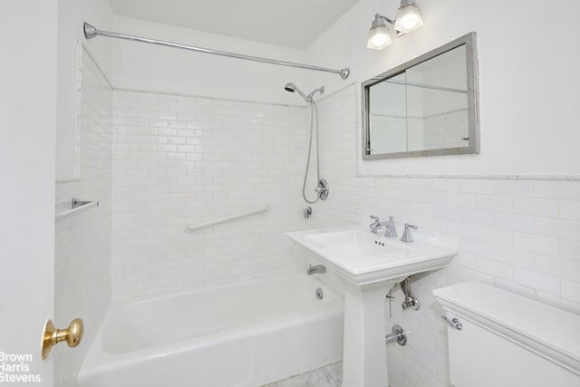 full bathroom with tile walls, toilet, and tub / shower combination