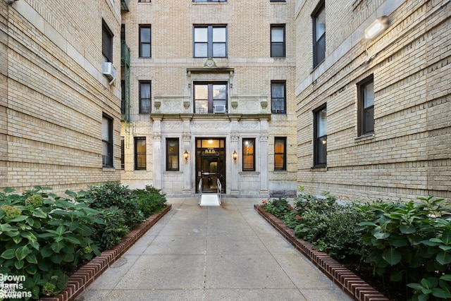 entrance to property featuring brick siding