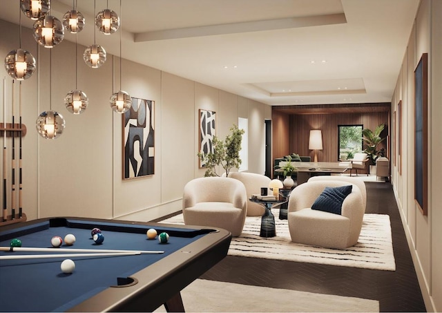 recreation room with hardwood / wood-style floors, pool table, and a raised ceiling