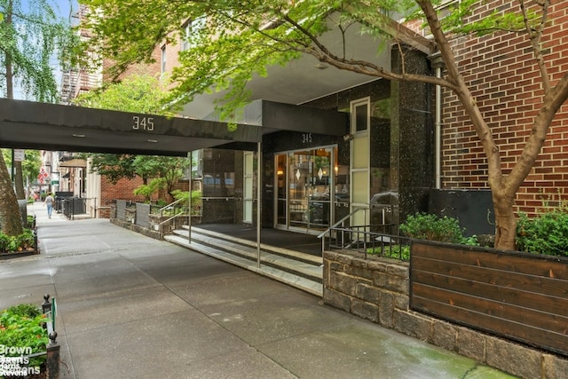 entrance to property featuring brick siding