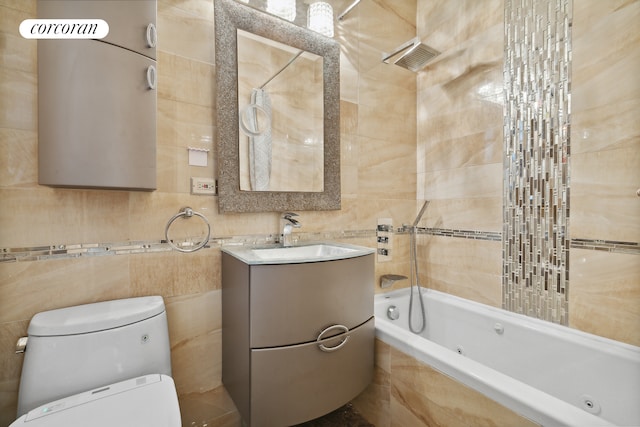 full bathroom with vanity, tile walls, toilet, and tiled shower / bath combo