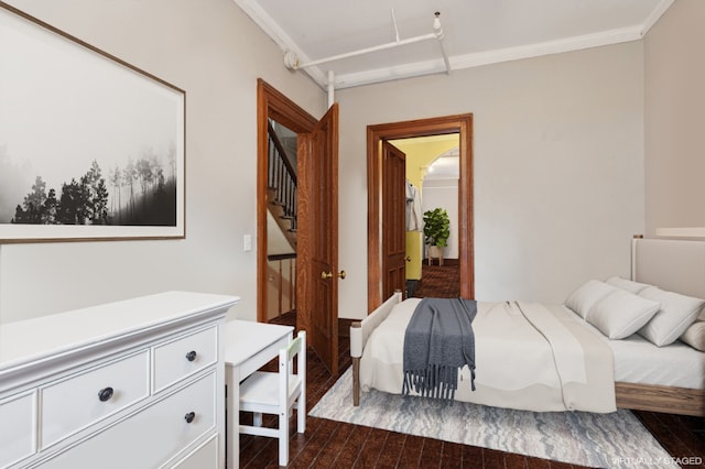 bedroom featuring ornamental molding and dark hardwood / wood-style floors