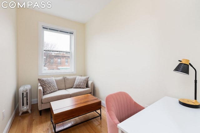 office space featuring hardwood / wood-style floors and radiator heating unit