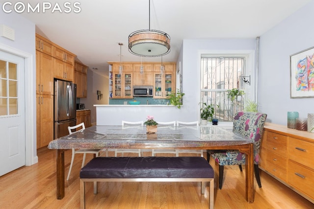 dining space with light hardwood / wood-style floors