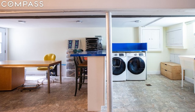 laundry room featuring cabinets and washer and clothes dryer