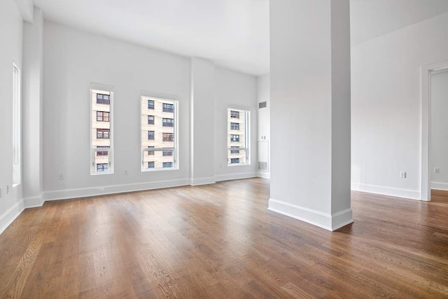 unfurnished room with dark wood-type flooring