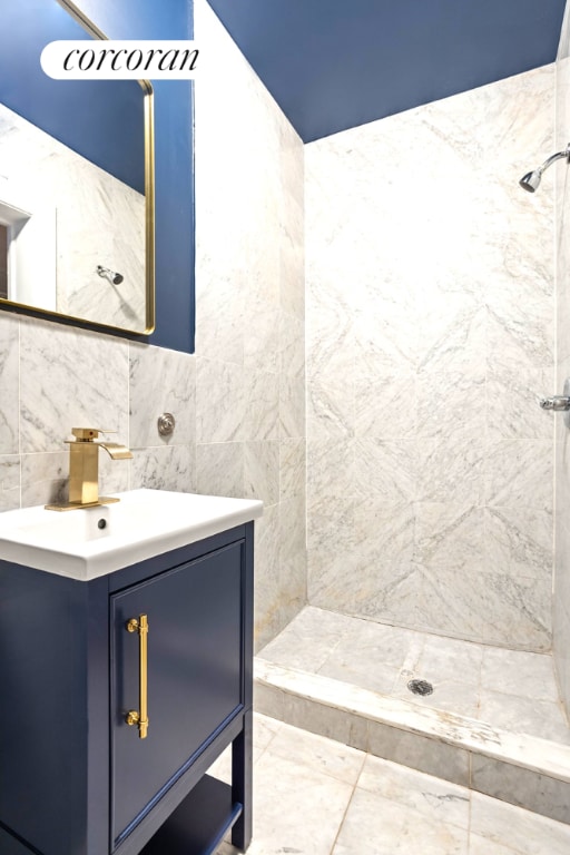 bathroom featuring backsplash, vanity, and a shower stall