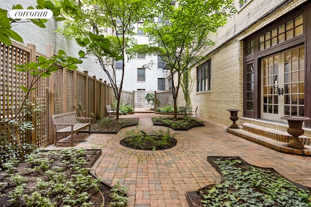 view of patio / terrace featuring french doors and fence