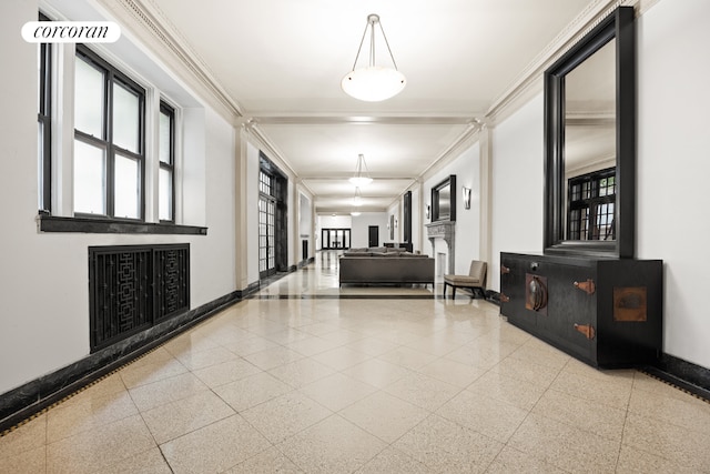 corridor with light speckled floor, crown molding, and baseboards