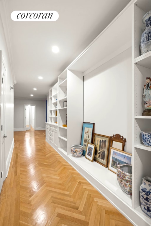 corridor featuring baseboards and recessed lighting