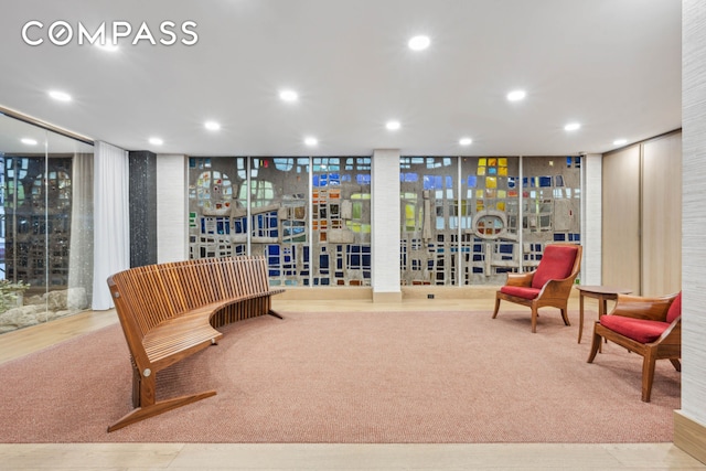 sitting room featuring recessed lighting and carpet