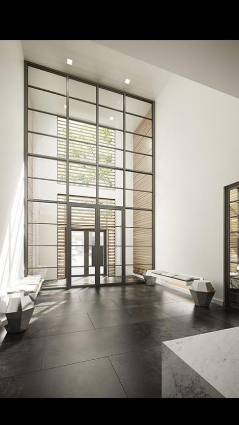 234 E 23rd St Unit 4-A, New York City, NY 10010 - community lobby featuring a wall of windows and a high ceiling