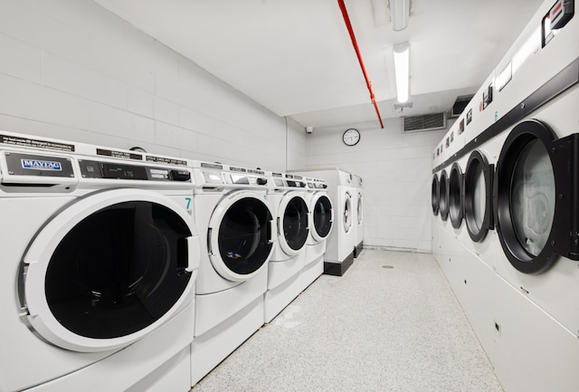 clothes washing area featuring independent washer and dryer