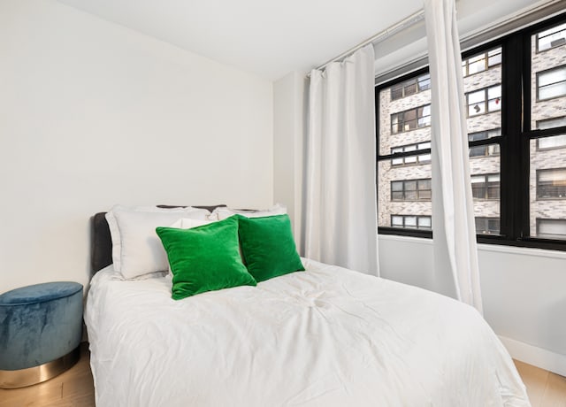 bedroom with hardwood / wood-style flooring