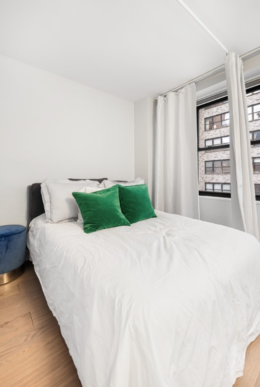 bedroom with wood-type flooring