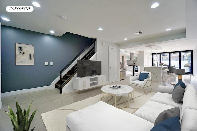 living room featuring light hardwood / wood-style floors and sink