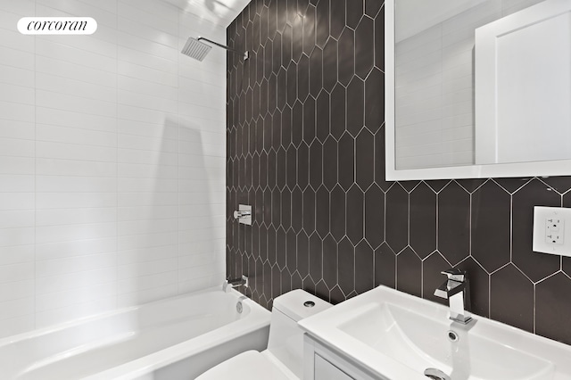 full bathroom featuring vanity,  shower combination, toilet, and tile walls