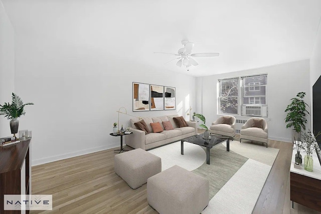 living room with light wood-style floors, ceiling fan, and baseboards