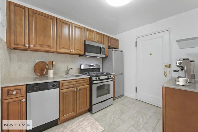 kitchen with stainless steel appliances, sink, and backsplash