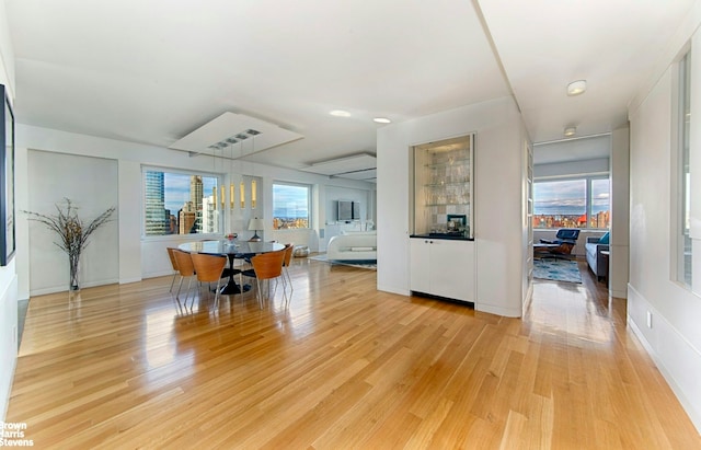 303 E 57th St Unit 46E, New York City, NY 10022 - dining area featuring light wood-style floors and baseboards