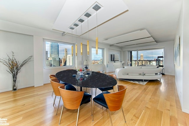 303 E 57th St Unit 46E, New York City, NY 10022 - dining area featuring wood finished floors and baseboards