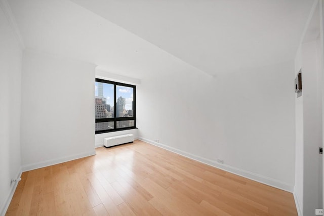 unfurnished room with light hardwood / wood-style flooring