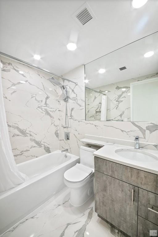 full bathroom featuring shower / bathtub combination with curtain, vanity, tile walls, and toilet