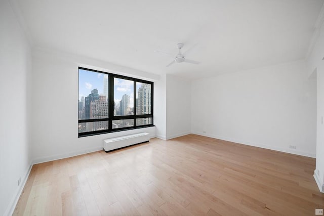 empty room featuring ceiling fan and light wood-type flooring