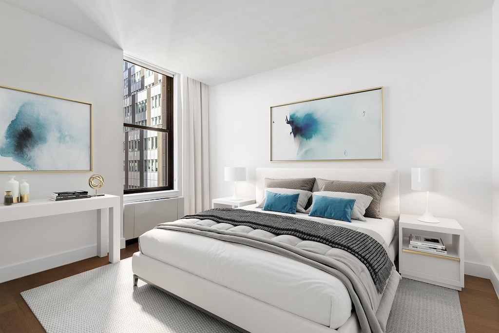 bedroom with wood finished floors and baseboards