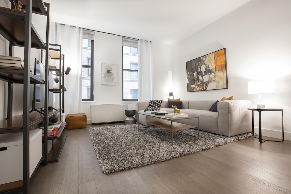 living room featuring wood finished floors and radiator