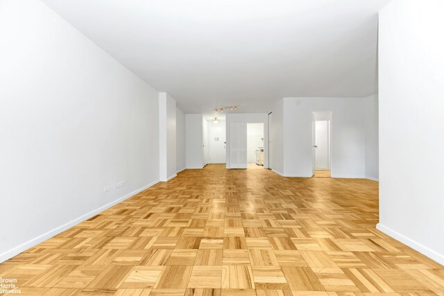 bedroom featuring radiator heating unit and light parquet flooring