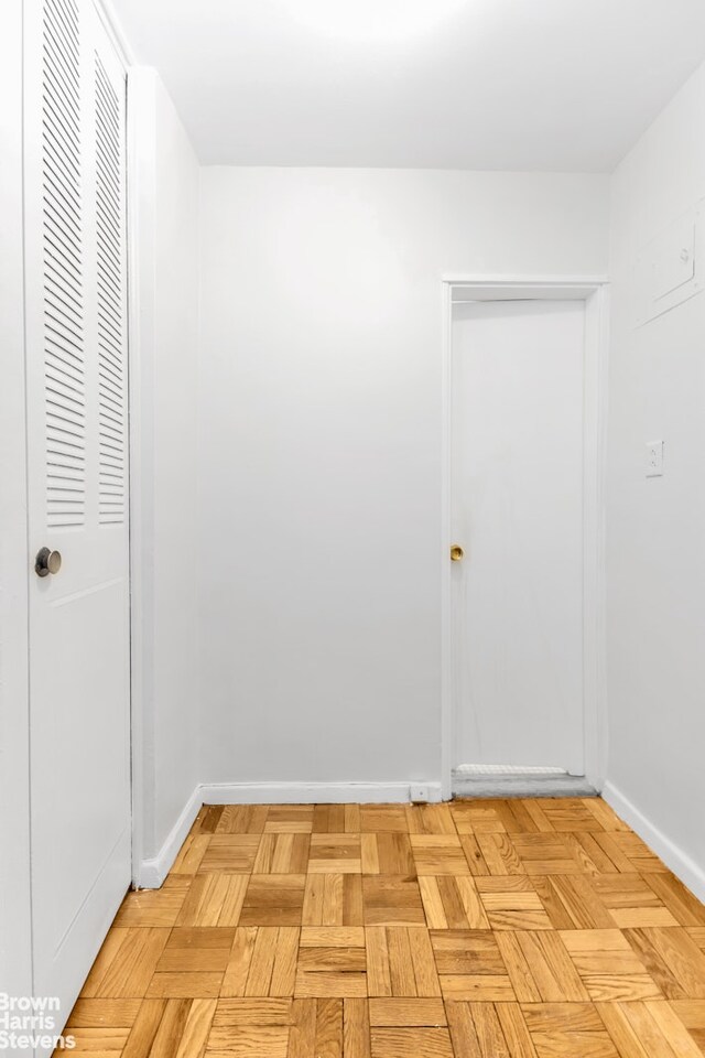 empty room with radiator heating unit and light parquet floors