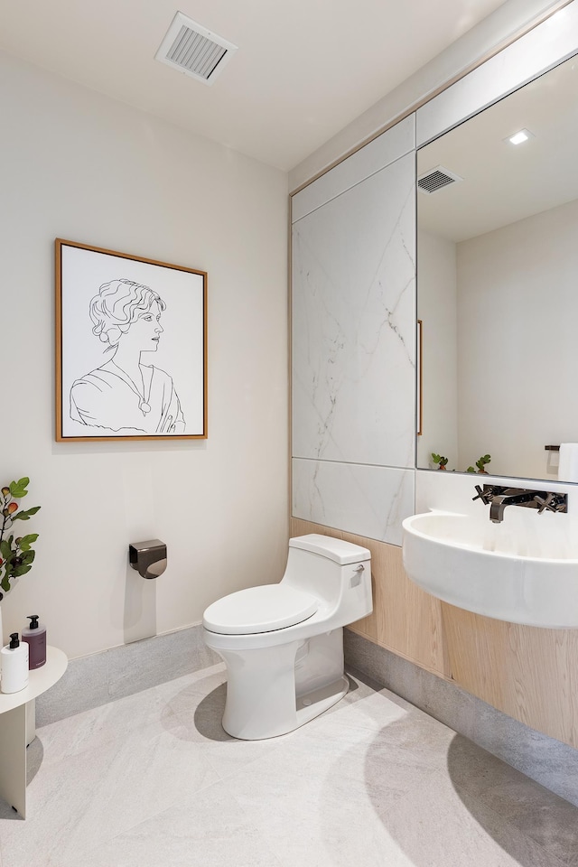 half bath featuring toilet and visible vents
