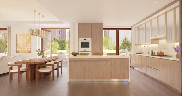201 E 74th St Unit 2A, New York City, NY 10021 - kitchen with light brown cabinetry, modern cabinets, white double oven, light countertops, and recessed lighting