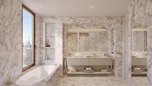201 E 74th St Unit 2A, New York City, NY 10021 - bathroom featuring marble tiled floors, double vanity, a garden tub, and tile walls
