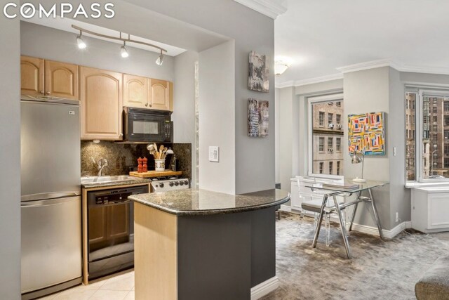 kitchen featuring black appliances, light brown cabinets, dark stone counters, tasteful backsplash, and crown molding