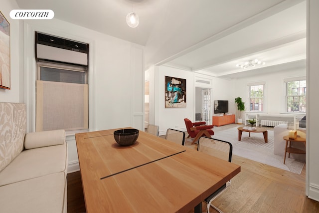 dining room with radiator and hardwood / wood-style floors