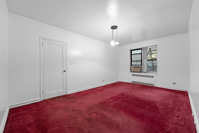 carpeted empty room with ornamental molding, baseboards, and radiator heating unit