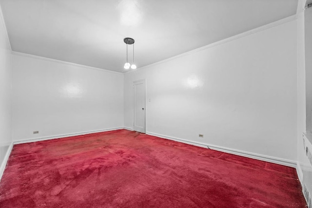 empty room with baseboards, carpet, and crown molding