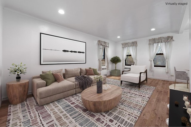 living area with crown molding, wood finished floors, and recessed lighting