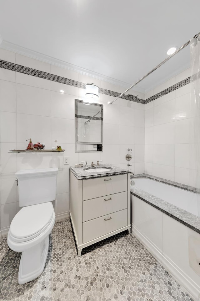 bathroom with toilet, shower / tub combo, vanity, tile walls, and ornamental molding