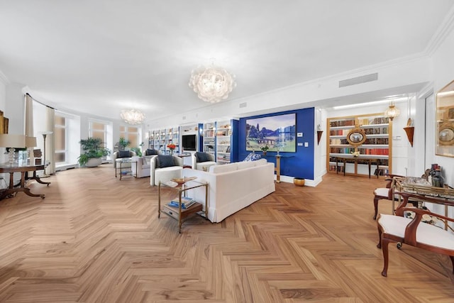 living room featuring light parquet flooring, built in features, ornamental molding, and an inviting chandelier