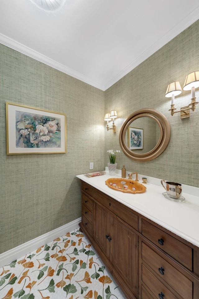 bathroom featuring crown molding, vanity, and wallpapered walls