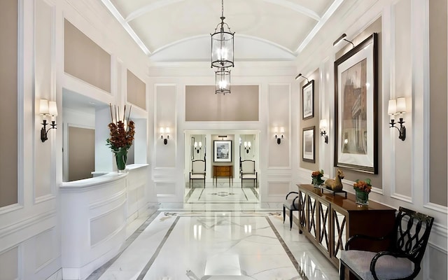535 W End Ave Unit 8A, New York City, NY 10024 - hall featuring a decorative wall, inlaid floor details, light marble finish floors, and lofted ceiling