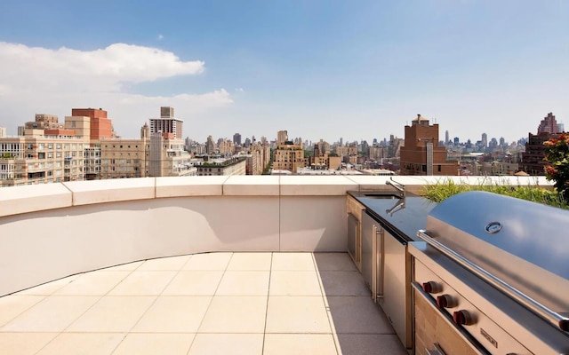 view of patio with a view of city, a sink, a balcony, and area for grilling